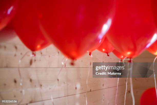 bunch of red balloons at a party or wedding - ballon festival stock-fotos und bilder