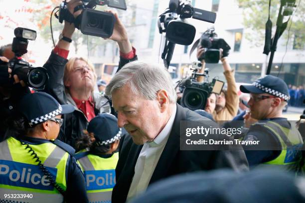 Cardinal George Pell walks through a police guard at Melbourne Magistrates' Court on May 1, 2018 in Melbourne, Australia. Cardinal Pell was charged...