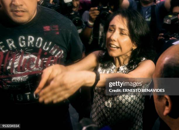 The wife of Peru's former President Ollanta Humala, Nadine Heredia is hounded by the press upon arrival at her house after being in preventative...