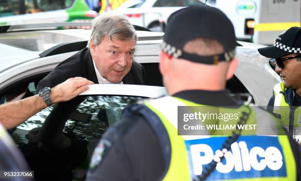 Vatican finance chief Cardinal George Pell arrives in court with a heavy police presence in Melbourne on May 1, 2018. - ll is appearing to hear a...