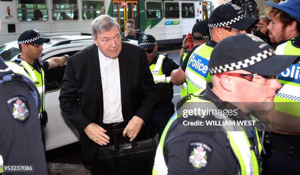 Vatican finance chief Cardinal George Pell arrives in court under a heavy police presence in Melbourne on May 1, 2018. - ll is appearing to hear a...