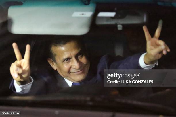 Peru's former President Ollanta Humala flashes the V sign in a car after being released from preventative detention awaiting trial on charges of...