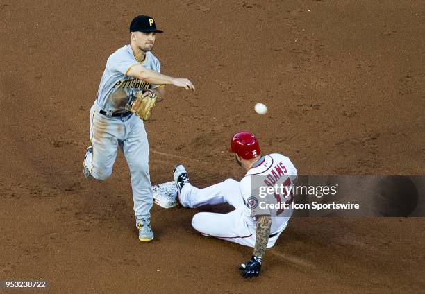 Pittsburgh Pirates second baseman Adam Frazier throws to first as Washington Nationals first baseman Matt Adams is late at second during a MLB game...