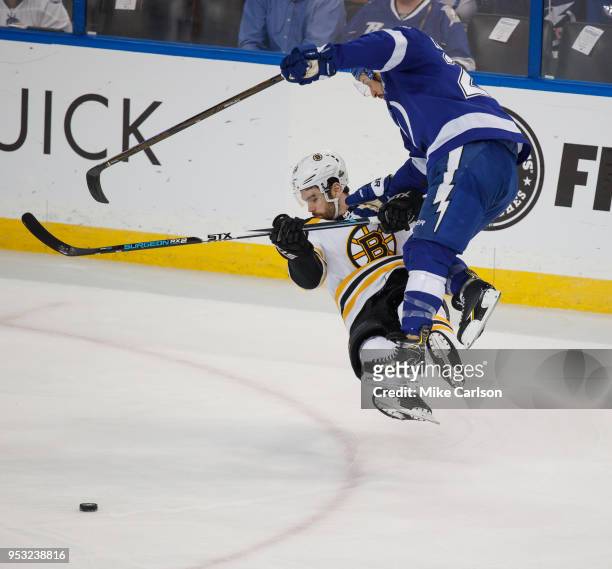 Ryan Callahan of the Tampa Bay Lightning checks Adam McQuaid of the Boston Bruins during Game Two of the Eastern Conference Second Round during the...