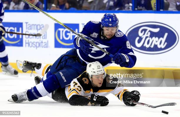Tyler Johnson of the Tampa Bay Lightning and Charlie McAvoy of the Boston Bruins fight for the puck during Game Two of the Eastern Conference Second...