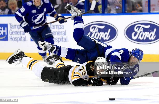 Tyler Johnson of the Tampa Bay Lightning and Charlie McAvoy of the Boston Bruins fight for the puck during Game Two of the Eastern Conference Second...