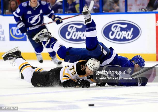 Tyler Johnson of the Tampa Bay Lightning and Charlie McAvoy of the Boston Bruins fight for the puck during Game Two of the Eastern Conference Second...