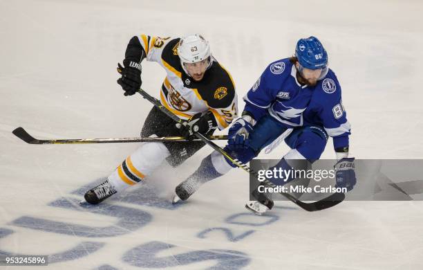 Nikita Kucherov of the Tampa Bay Lightning skates against Brad Marchand of the Boston Bruins during Game Two of the Eastern Conference Second Round...