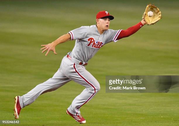 Scott Kingery of the Philadelphia Phillies makes a play for the ball in the third inning against the Miami Marlins at Marlins Park on April 30, 2018...