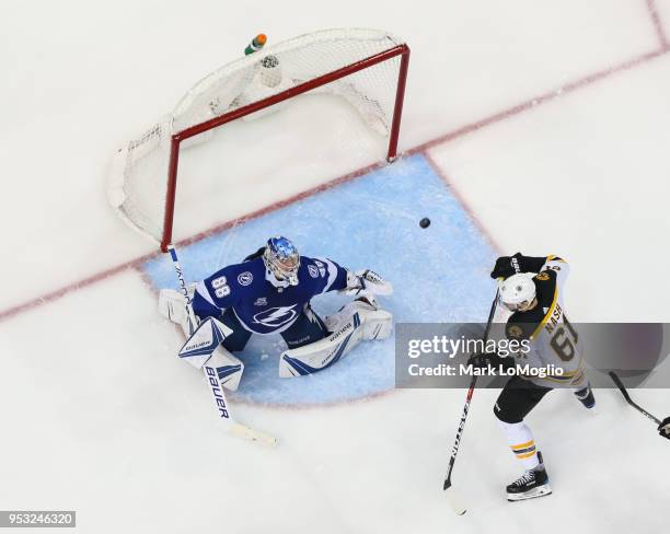 Goalie Andrei Vasilevskiy of the Tampa Bay Lightning watches the flying puck against Rick Nash of the Boston Bruins during Game Two of the Eastern...