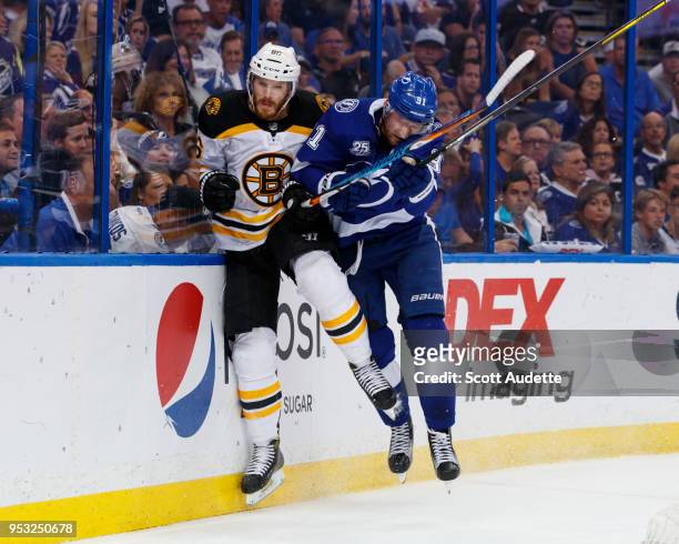 Steven Stamkos of the Tampa Bay Lightning checks Kevan Miller of the Boston Bruins during Game Two of the Eastern Conference Second Round during the...