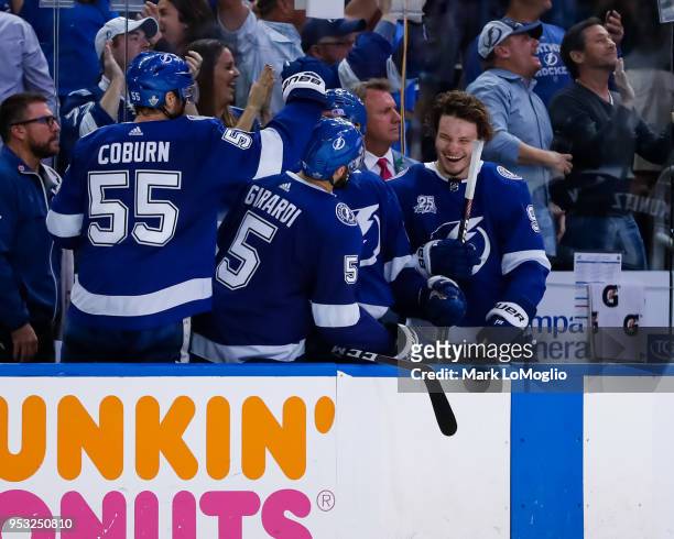 Braydon Coburn, Dan Girardi, and Mikhail Sergachev of the Tampa Bay Lightning celebrate a goal against the Boston Bruins during Game Two of the...