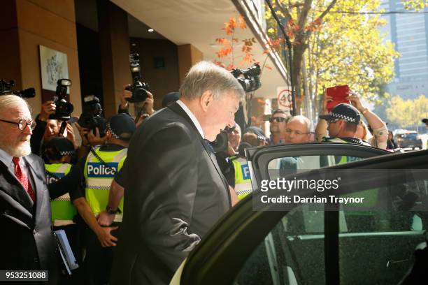 Cardinal George Pell walks through a police guard to a waiting car outside Melbourne Magistrates' Court on May 1 at Melbourne 1, 2018 in Melbourne,...