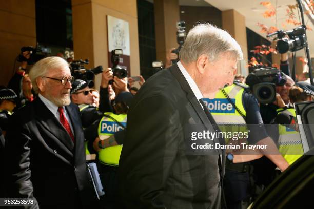 Cardinal George Pell walks through a police guard to waiting car outside Melbourne Magistrates' Court on May 1 at Melbourne 1, 2018 in Melbourne,...