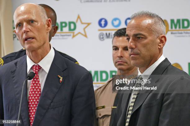 Florida Gov. Rick Scott, left, talks alongside Andrew Pollack, whose daughter Meadow was murdered in Parkland, and Miami-Dade County mayor Carlos A....