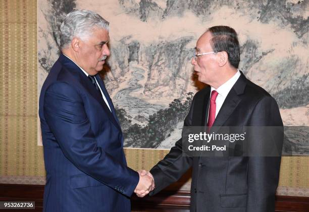 Chinese Vice President Wang Qishan shakes hand with Dominican Republic's Chancellor Miguel Vargas at the Zhongnanhai Leadership Compound on May 1,...