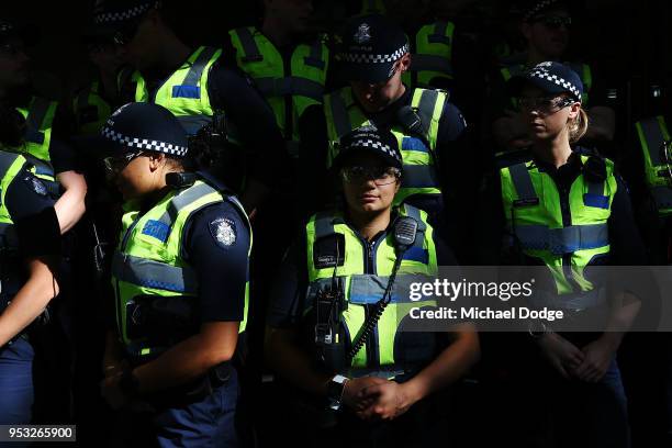 Police officers get ready to barricade Cardinal George Pell from media and protestors at Melbourne Magistrates' Court on May 1, 2018 in Melbourne,...