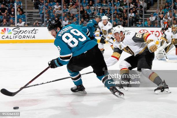 Mikkel Boedker of the San Jose Sharks keeps the puck away from Nate Schmidt of the Vegas Golden Knights in Game Three of the Western Conference...