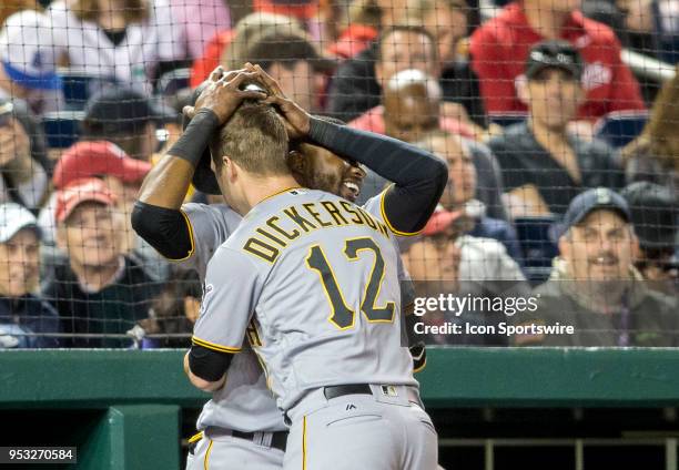 Pittsburgh Pirates right fielder Gregory Polanco removes the helmet of home run hitter left fielder Corey Dickerson in the dugout during a MLB game...