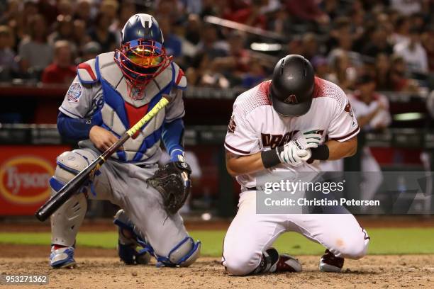 David Peralta of the Arizona Diamondbacks reacts after being hit by a pitch in fromt of catcher Yasmani Grandal of the Los Angeles Dodgers during...