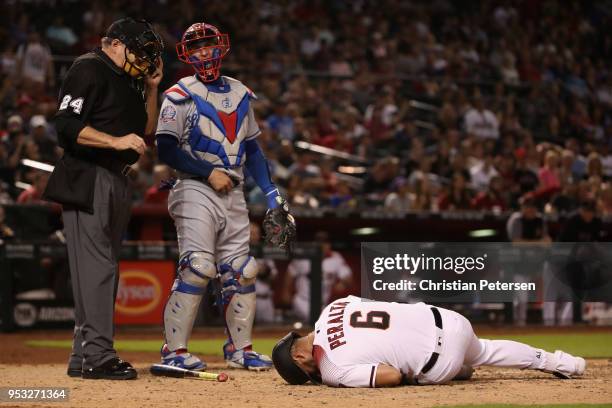 David Peralta of the Arizona Diamondbacks reacts after being hit by a pitch in fromt of catcher Yasmani Grandal of the Los Angeles Dodgers during...