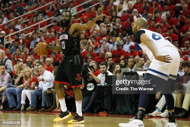 James Harden of the Houston Rockets controls the ball defended by Taj Gibson of the Minnesota Timberwolves in the first half during Game Five of the...