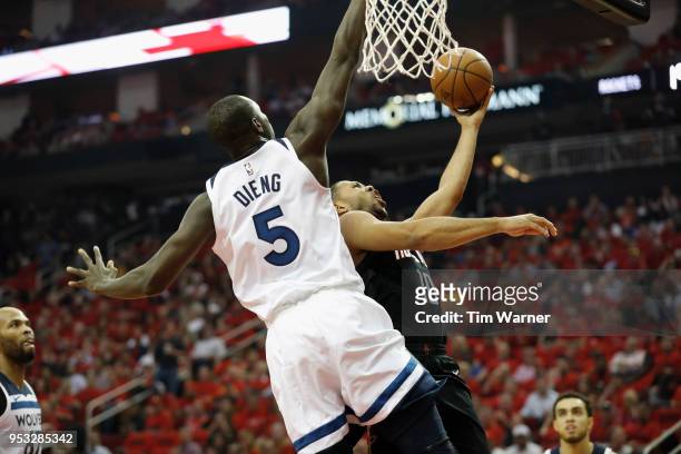 Eric Gordon of the Houston Rockets goes up for a shot defended by Gorgui Dieng of the Minnesota Timberwolves in the first half during Game Five of...