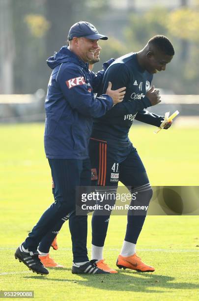 Jean-Paul de Marigny the assistant coach of the Victory speaks to Leroy George during a Melbourne Victory A-League training session at Gosch's...
