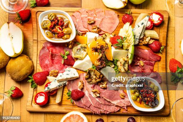 cold meat appetizers with fruits, cheese and wine - table aperitif stock pictures, royalty-free photos & images