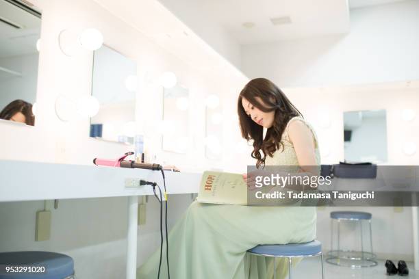 woman reading musical score at backstage dressing room - 舞台裏　日本 ストックフォトと画像