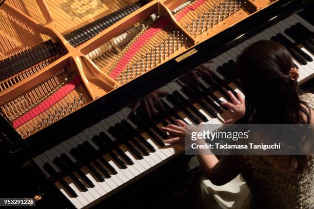 woman playing the piano - pianist woman stock pictures, royalty-free photos & images