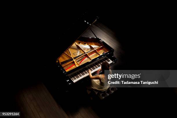 woman playing the piano - pianist woman stock pictures, royalty-free photos & images