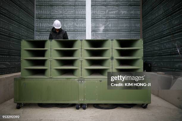 Worker dismantles loudspeakers that were set up for propaganda broadcasts near the demilitarized zone separating the two Koreas in Paju on May 1,...