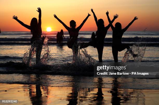 Students from the University of St Andrews take part in the traditional May Day Dip on the East Sands in St Andrews, Fife. Plunging into the freezing...