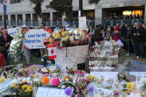 Flowers and messages of condolence at a memorial during an inter-faith vigil at Nathan Phillips Square in memory of the 10 people killed and 15...