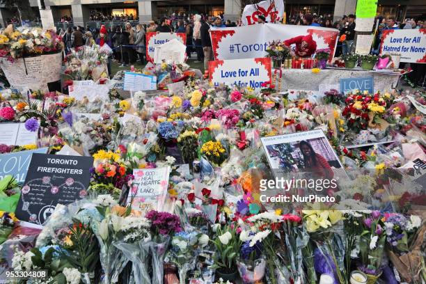 Flowers and messages at a memorial during an inter-faith vigil at Nathan Phillips Square in memory of the 10 people killed and 15 people injured in a...