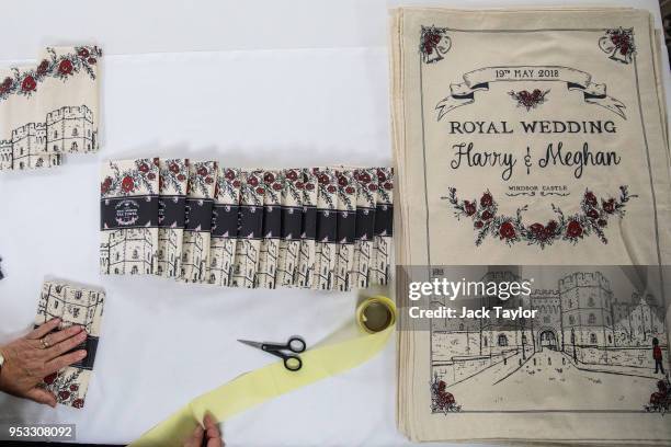 Worker Lynne Needham folds and packages commemorative tea towels by Victoria Eggs to mark the wedding of Prince Harry to Meghan Markle at Countryside...