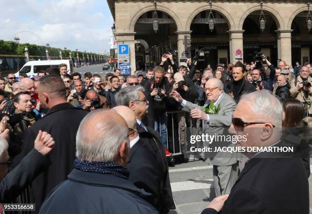 France's far-right Front National party founder and former leader Jean-Marie Le Pen gestures as he arrives at the Place des Pyramides in Paris to...