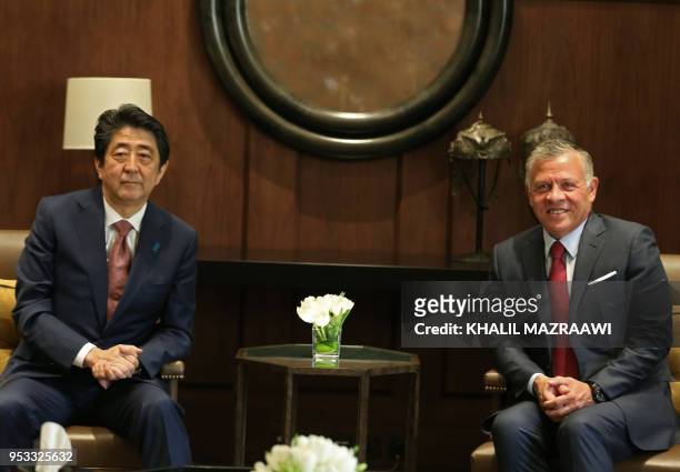 Japanese Prime Minister Shinzo Abe talks with Jordanian King Abdullah II at the Jordanian Royal Palace in Amman on May 1, 2018.