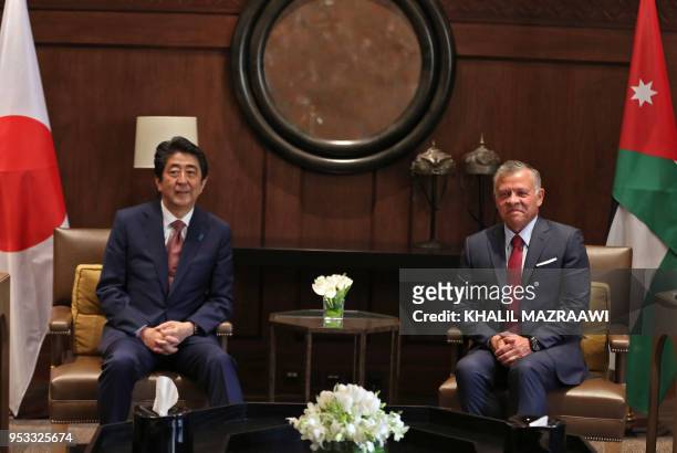 Japanese Prime Minister Shinzo Abe talks with Jordanian King Abdullah II at the Jordanian Royal Palace in Amman on May 1, 2018.