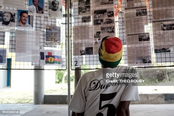 Man from the Wakatr tribe look at old newspaper clippings as part of the commemoration ceremonies in tribute to victims of the 1988 hostage crisis,...