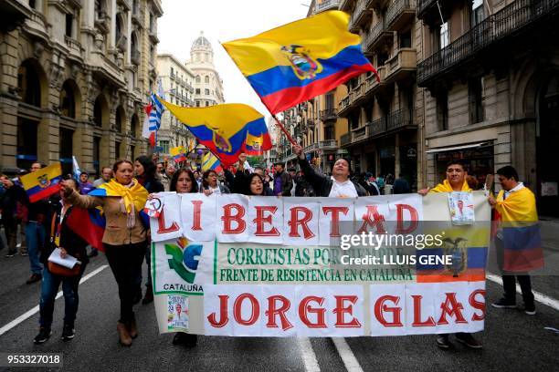 People march with Ecuadorian flags with a banner calling for the release of Ecuador's former vice president Jorge Glas during a May Day rally in...