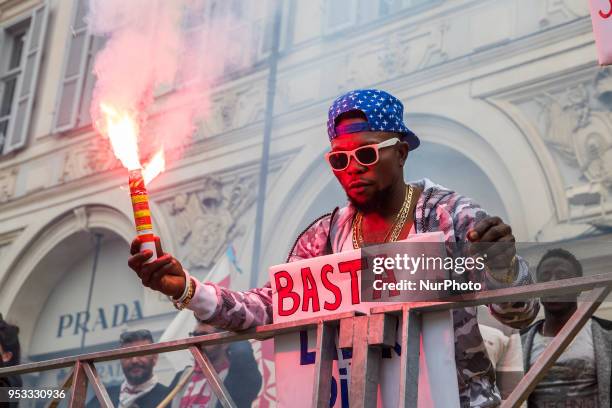 Man showing a fire torch up high during Mayday Commemoration in Turin, Italy, on 1st May 2018. Mayday in Turin was held without incident in the...