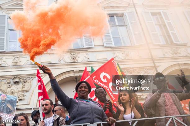 Woman showing a fire torch up high during Mayday Commemoration in Turin, Italy, on 1st May 2018. Mayday in Turin was held without incident in the...