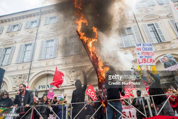 Protester sets fire to a Turkish flag during the may day rally in downtown during Mayday Commemoration in Turin, Italy, on 1st May 2018. Mayday in...