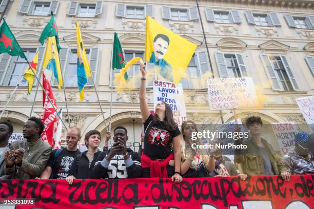 Woman showing a fire torch up high during Mayday Commemoration in Turin, Italy, on 1st May 2018. Mayday in Turin was held without incident in the...