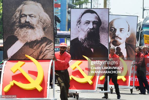 Supporters of the Frontline Socialist Party display placards with the images of Karl Marx, Friedrich Engels and Vladimir Lenin as they take part on a...