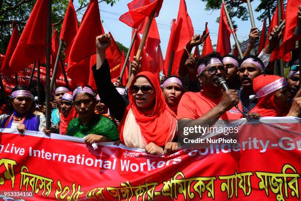 Bangladeshi garment workers and other labor organization members take part in a rally to mark May Day, International Workers' Day in Dhaka,...