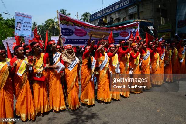Bangladeshi garment workers and other labor organization members take part in a rally to mark May Day, International Workers' Day in Dhaka,...