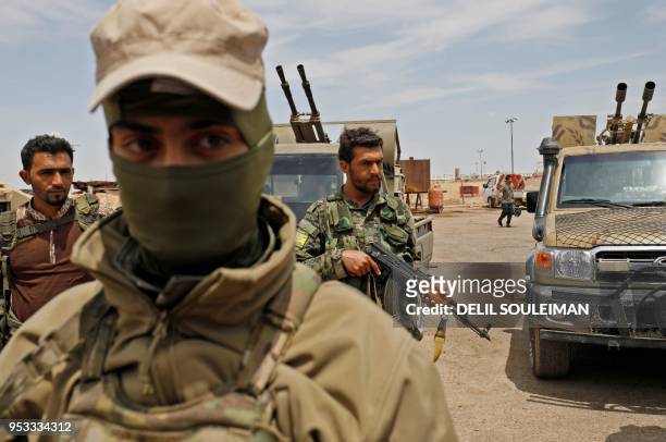 Members of the Syrian Democratic Forces gather at the al-Tanak oil field as they prepare to relaunch a military campaign against the Islamic State...